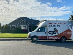 White and maroon CPI plumbing and heating service van with "Don't Cry, Call CPI" branding parked in front of a residential home.